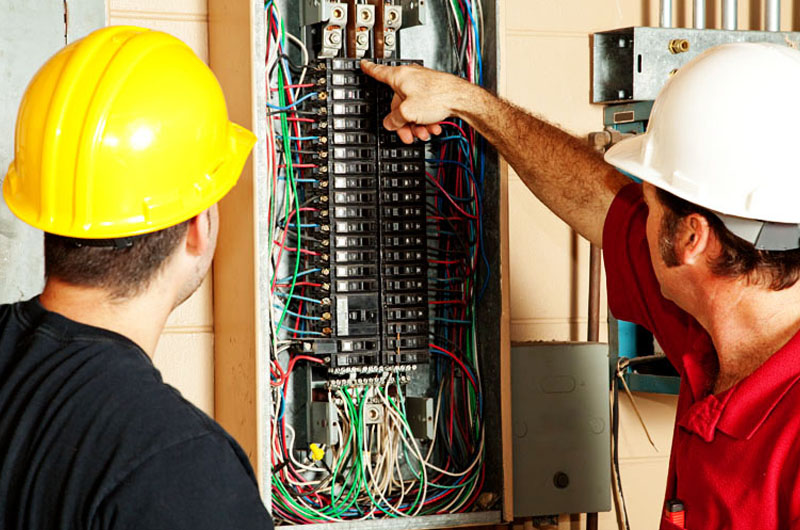 Two contractors fixing electrical problems