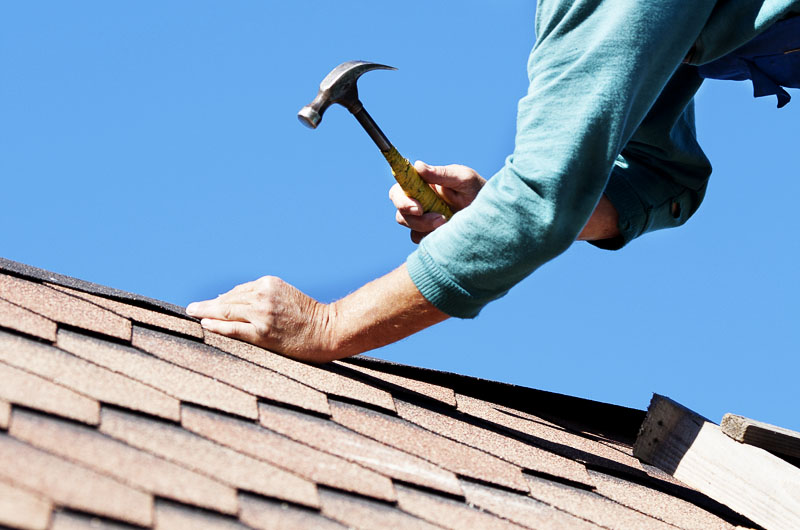 A person fixing the roof