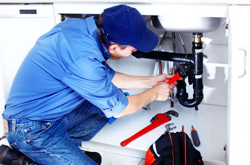 a plumber fixing a pipe